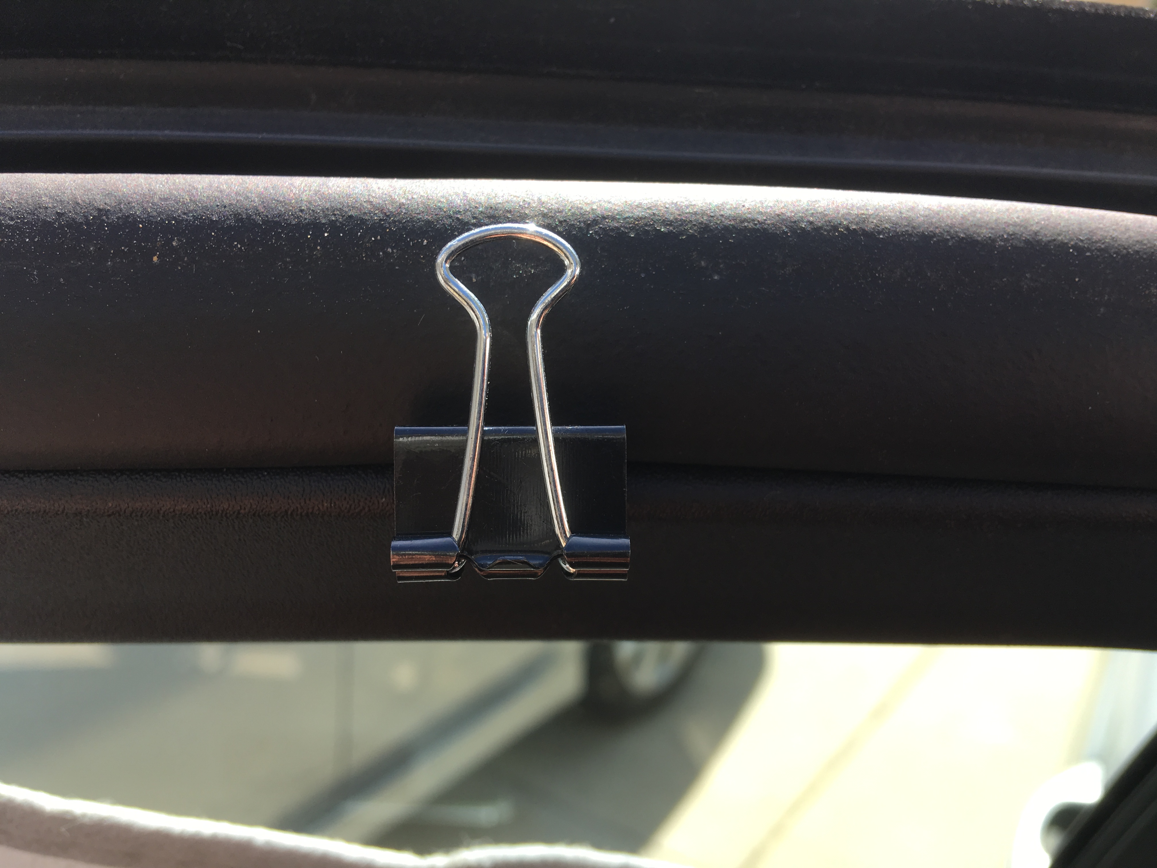 Slide arm of chip clip in headliner or window gasket to hold privacy curtains.