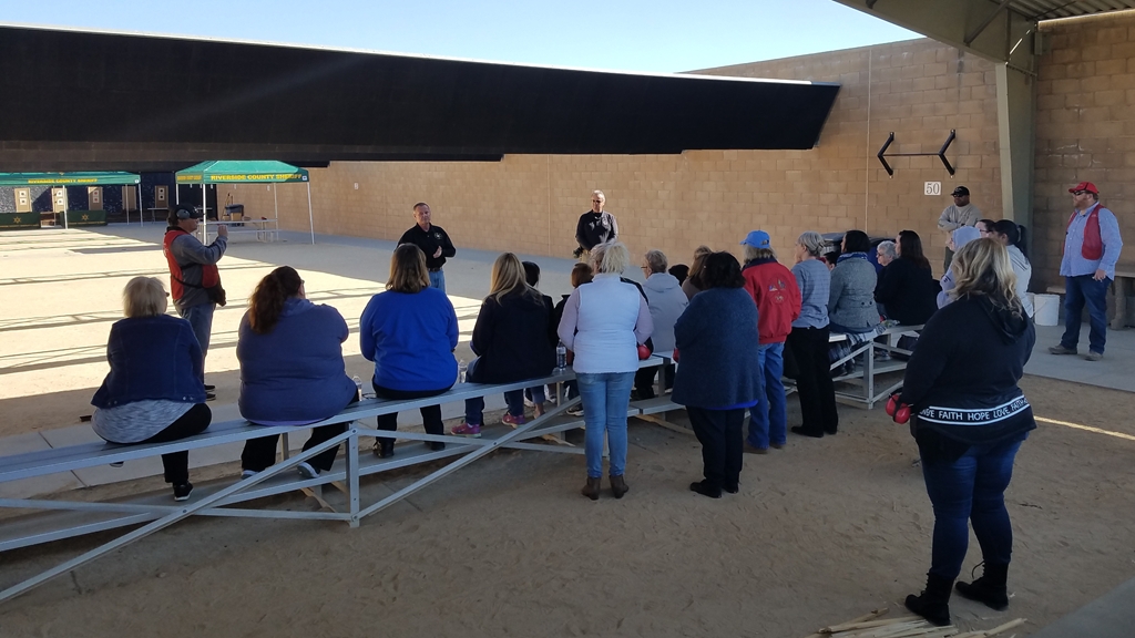 Sheriff Sniff speaking the group of women shooters.