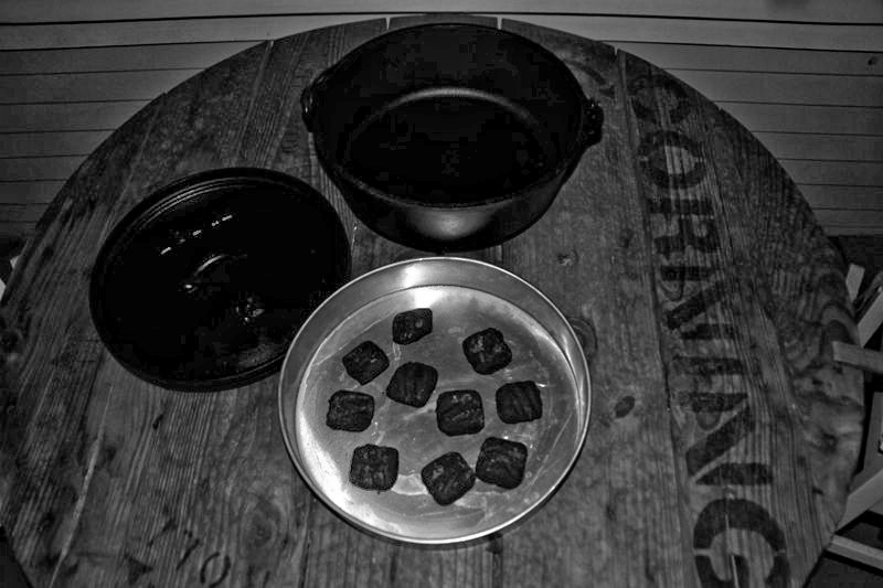 Pie tin from Smart and Final (credit KI6FHA) used to shield coals from the wind and concentrate the heat at the bottom of the oven.  Also for those areas where fire/coal residue cannot be left behind.