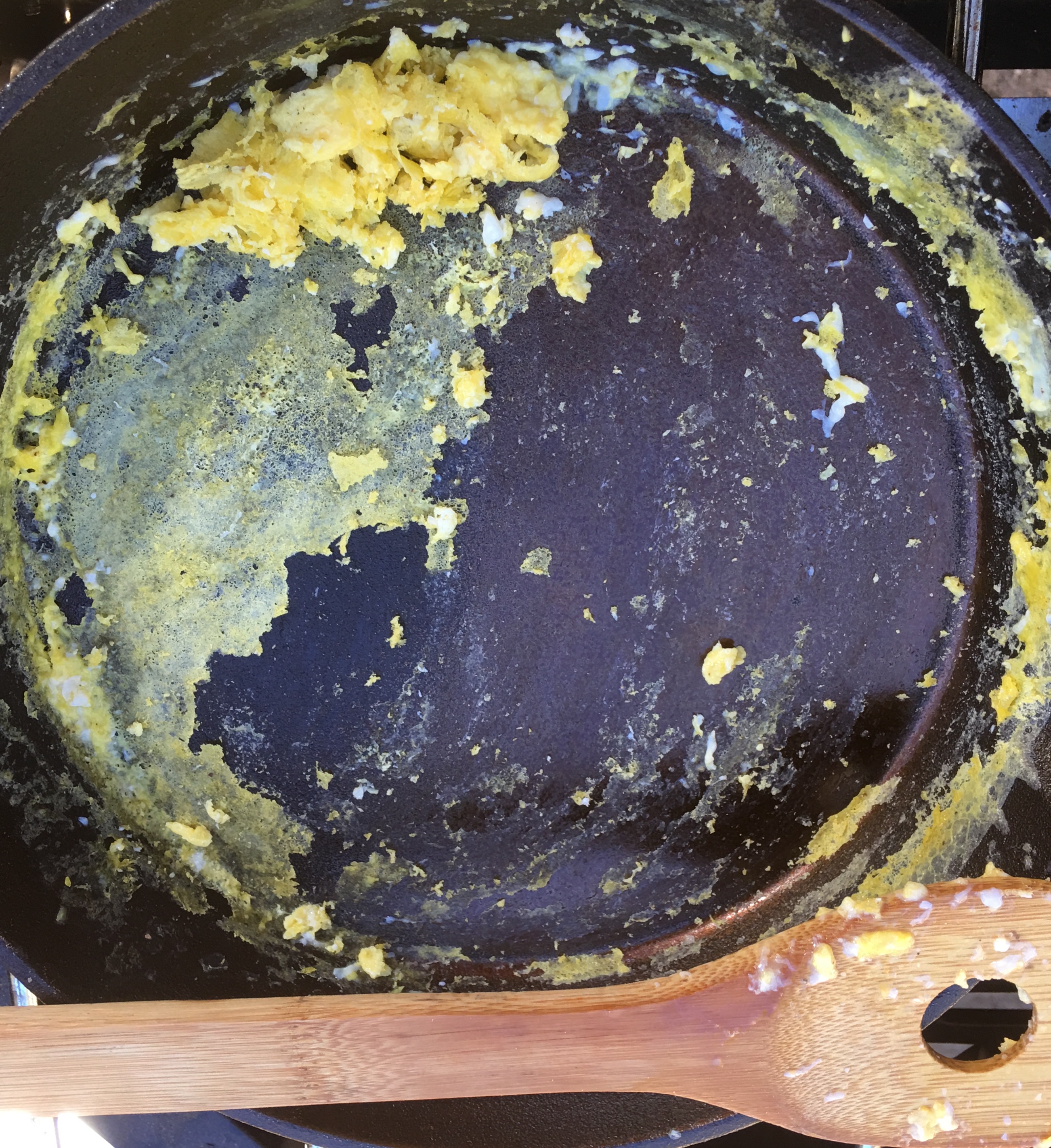 Eggs stuck in the low points of the equally seasoned pan.
