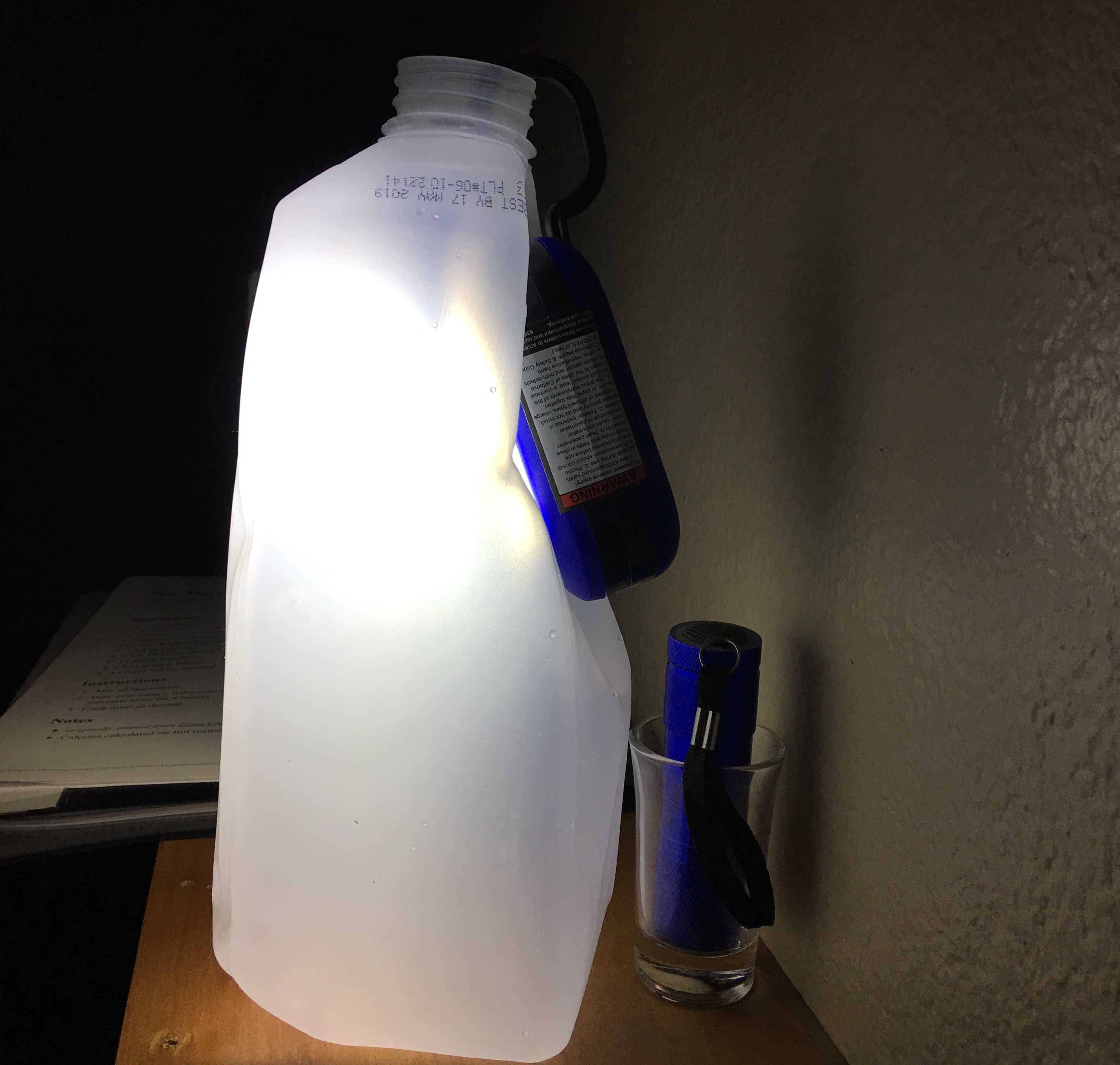 Flashlight attached to empty milk jug