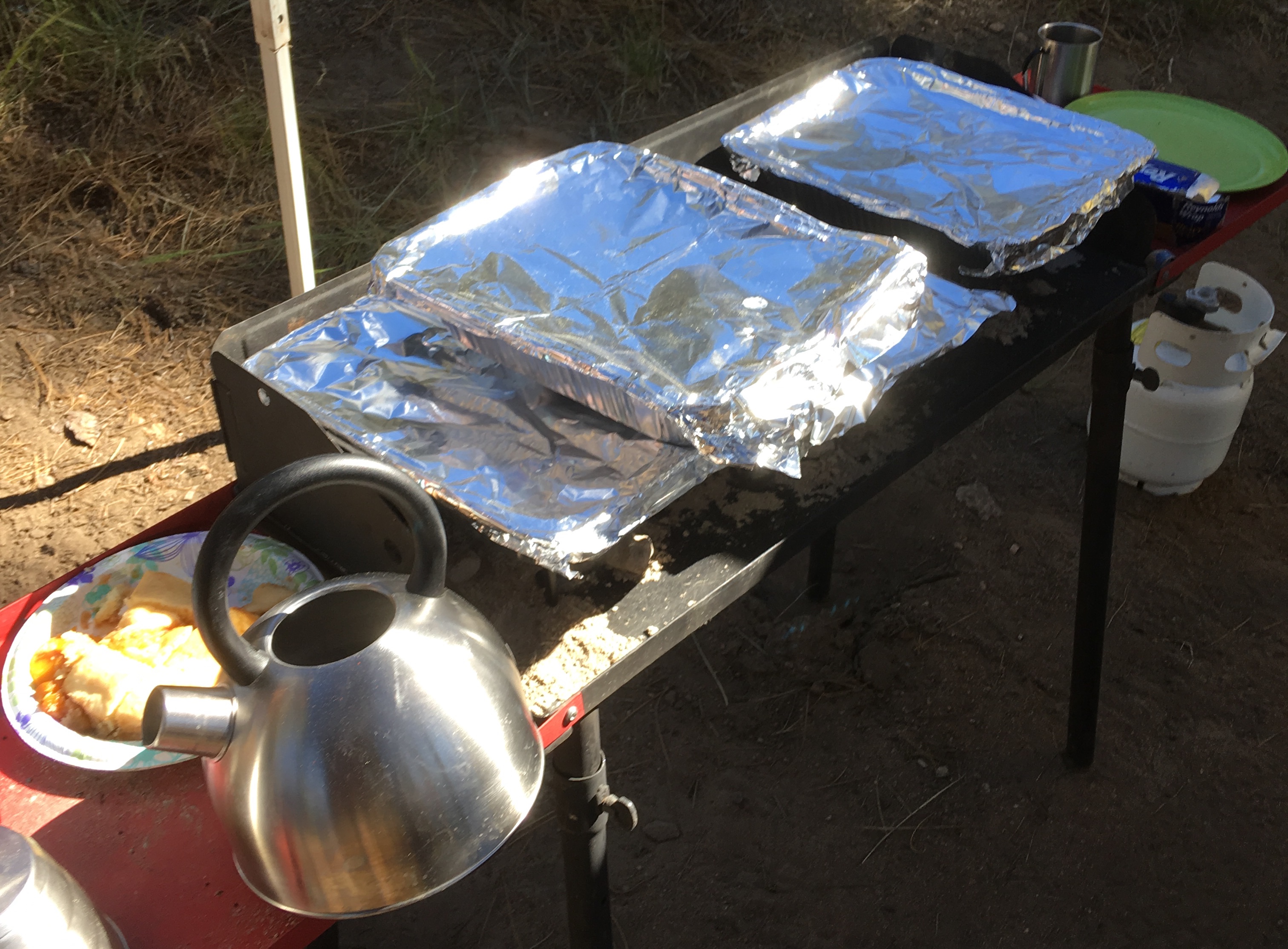 We use aluminum pans with coals underneath to keep food warm. We need to make 20 or more sandwiches