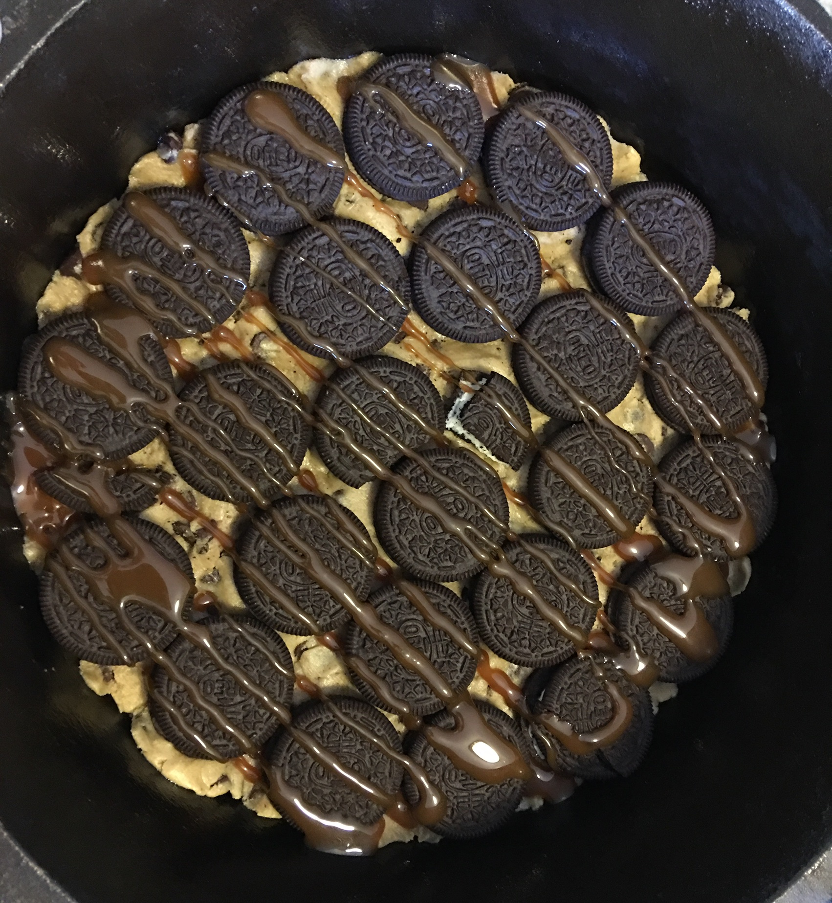 Layer of pre-made or fresh made cookie dough. Layer of Oreos. Carmel or PB.