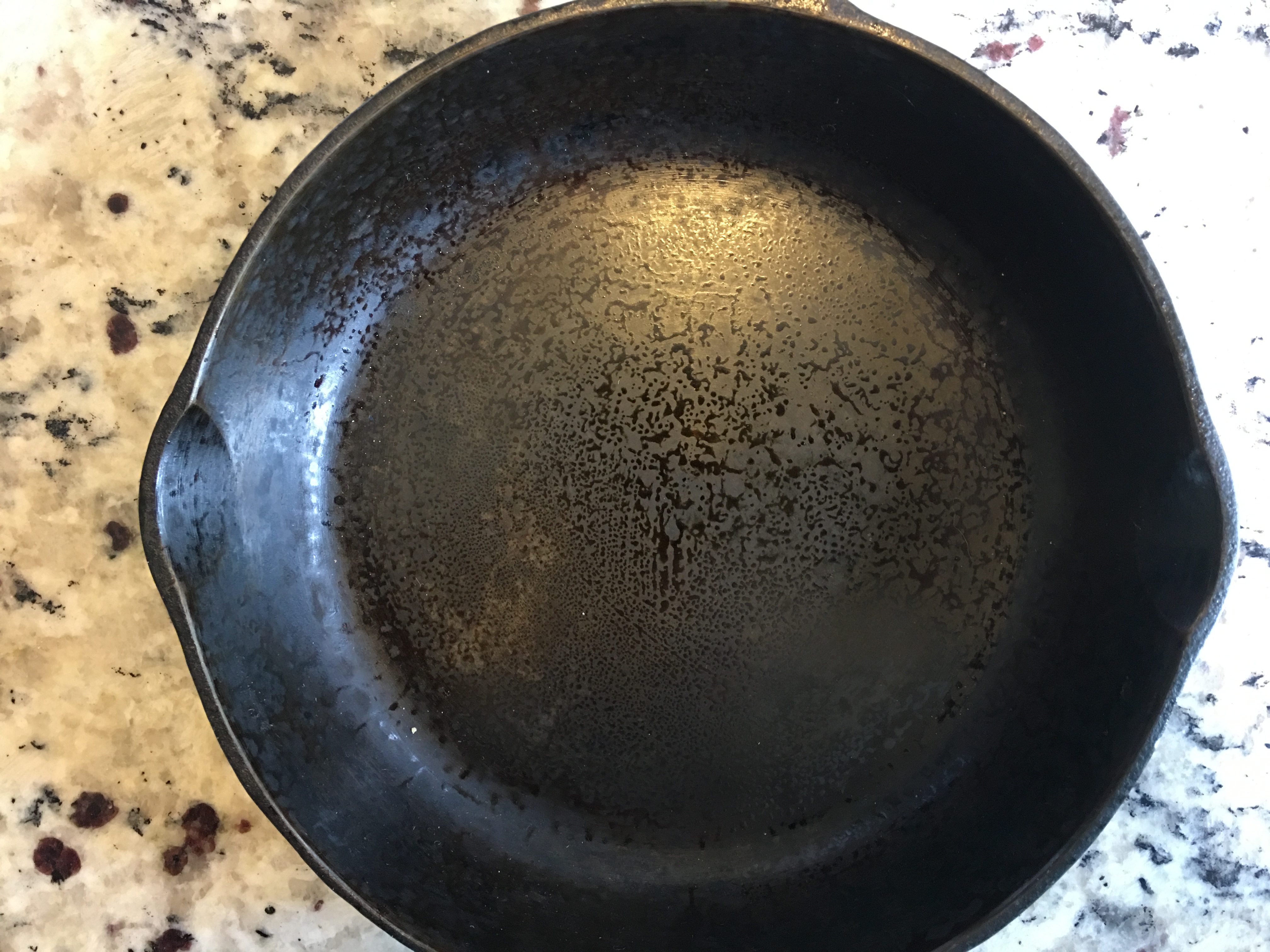 Two things to note about this older Wagner pan. The surface of the pan came smooth from the factory. I left too much oil in the pan and it pooled and the cured on the surface.
