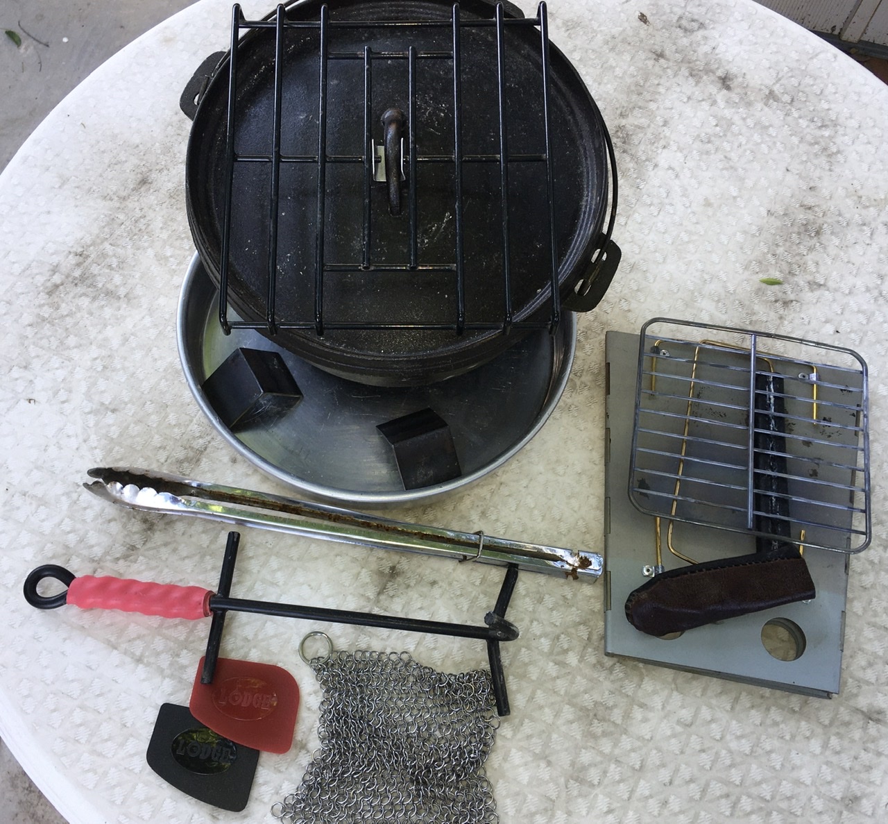 I am one of those people that has a Dutch oven without legs, although it has a traditional lid. I use small pieces of angle iron to replace them.