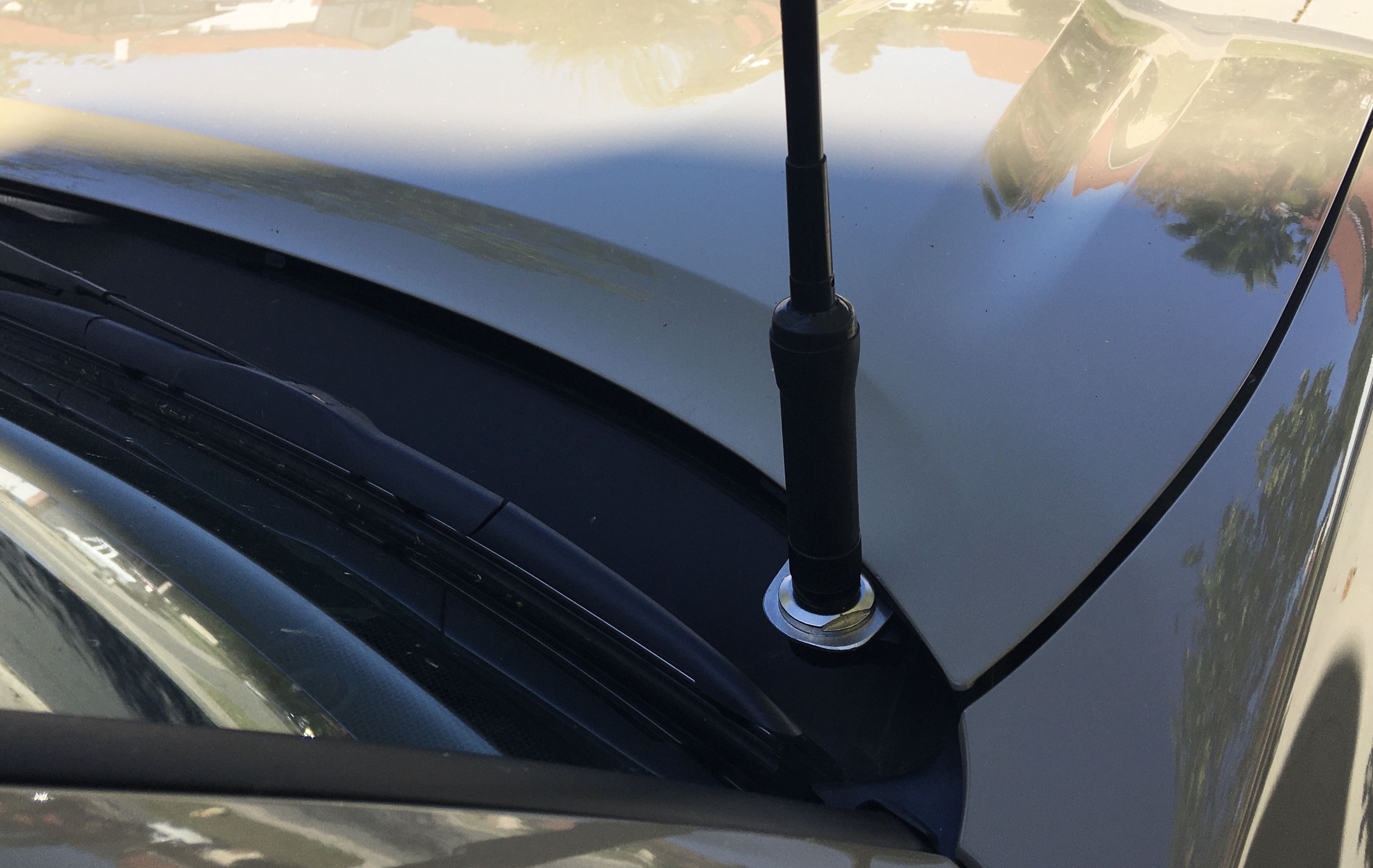 I fabricated an aluminum mount for the antenna. It is attached to the hood bolts.  I like this location because it is out of the way and fairly protected. It seems to work very well.