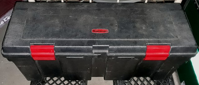 Large secondhand Rubbermaid box, non-conductive and able to handle two 75AH AGM batteries.