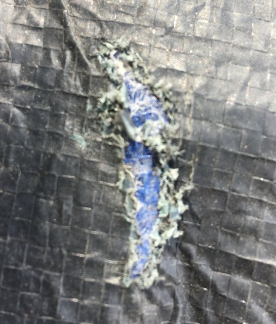 Damaged tent vinyl floor.