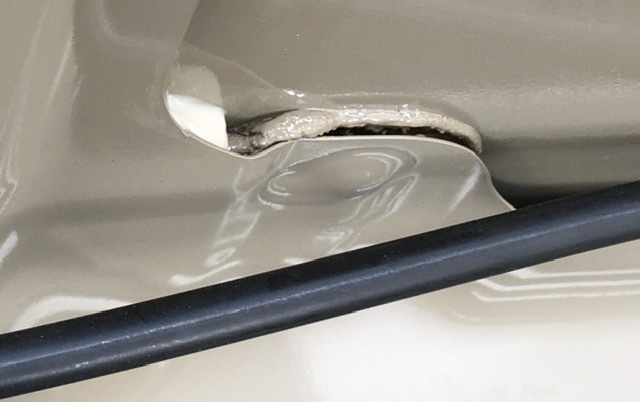 Delamination of the factory foam supporting a cars hood skin.