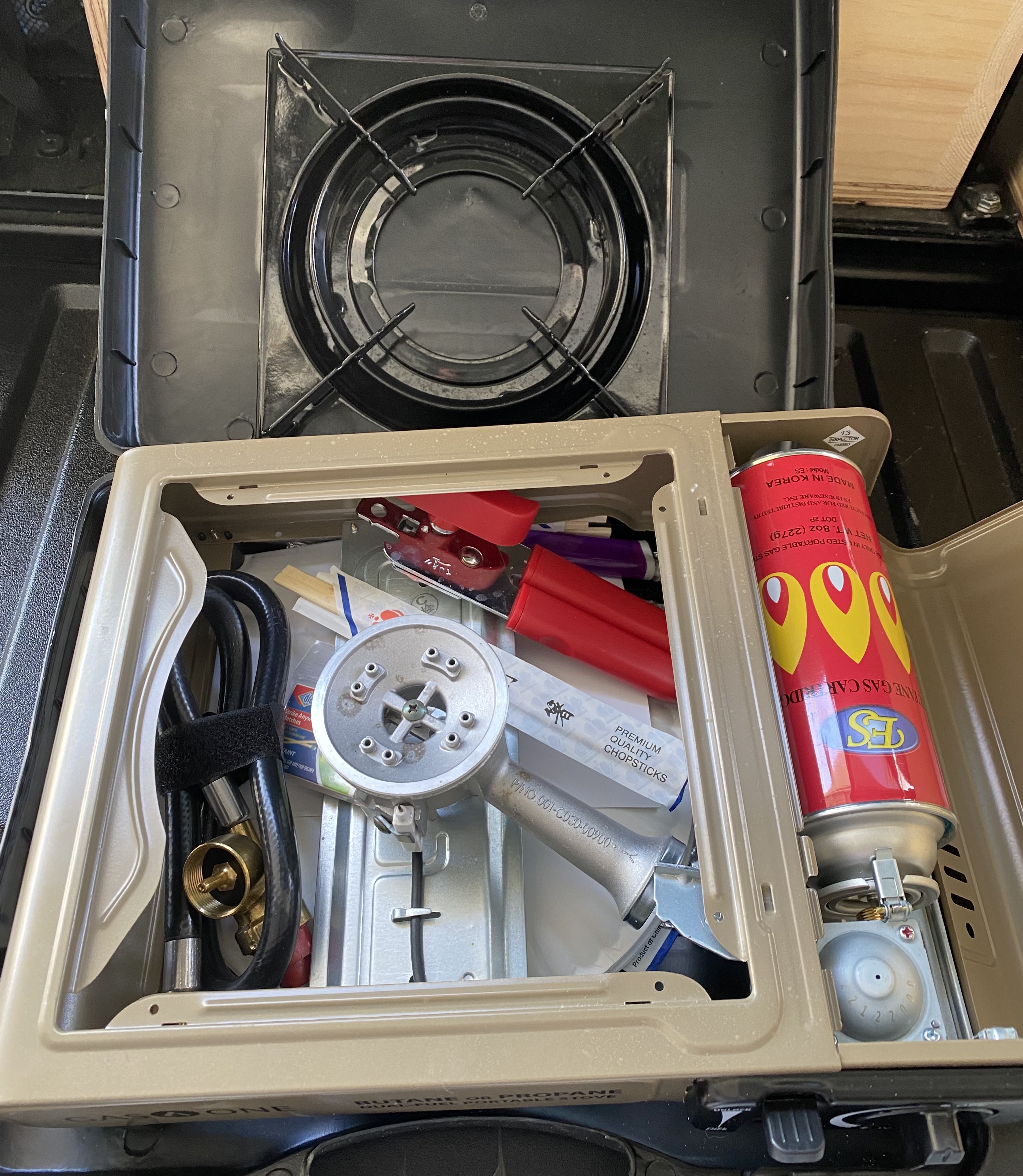 With the stove inside the included plastic case, there is plenty of room for the propane hose, utensils, paper plates and additional items. There is also a fuel canister inside but not engaged.
