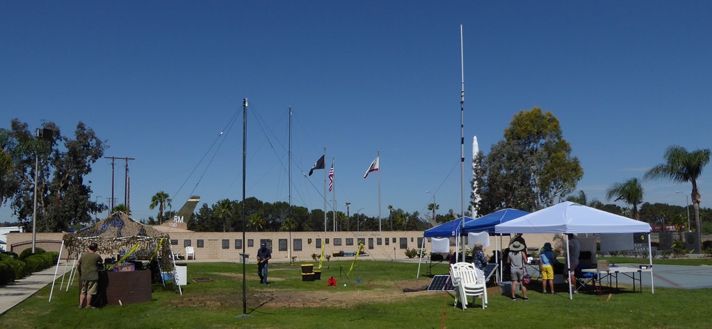 This is a view of the overall site as you passed the GOTA station.  It is a little busy because there is a lot going on.  Represented are two inverted-V antennas representing 6m and 10m (front-center-left).  There is an Ed Fong style antenna for VHF/UHF (center-right white vertical) and two wire antennas. one a close to horizontal dipole, the other an off-center-fed dipole (both hard to pick out in this photo).