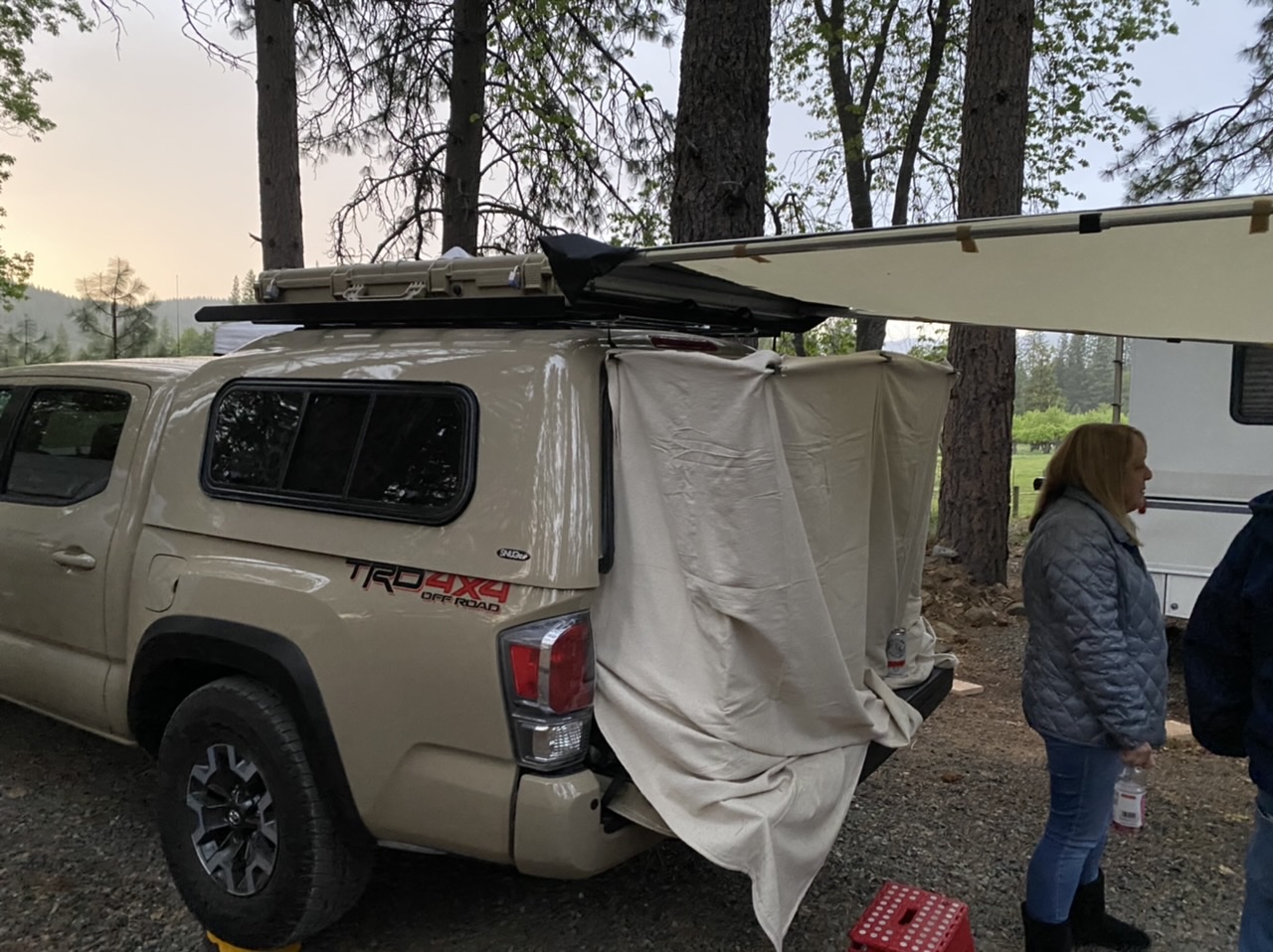 The truck topper is set up as a 6.5’ sleeper for 2. I use the drawers to extend the bed platform from 5’ to 6.5’ by pulling them out onto the tailgate. A waterproofed cotton drop cloth encloses the open tailgate but is very quiet even in strong winds.