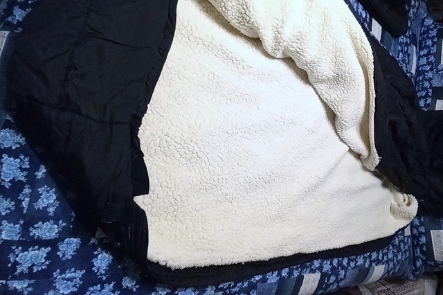 The fleece is long and over-sized for the bag so it is like a cocoon when she is cold and gets all situated.  She has the first quarter of the fleece boxed in with stitching and the rest just folds over and  used as a liner/blanket.