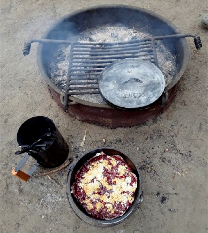 Sometimes the right tools and recipe go a long way. This is an example of a charcoal starter, the lid lifter and probably some gloves off to the side that help get the coals ready for a traditional Dutch oven cook where the lid of the Dutch oven is made to keep the briquettes on top and the legs leave room for them underneath. A rotation every 15 minutes will ensure you don't overheat in any one spot. I think I got a water heater pan to keep the coals and fire danger contained (not shown here).