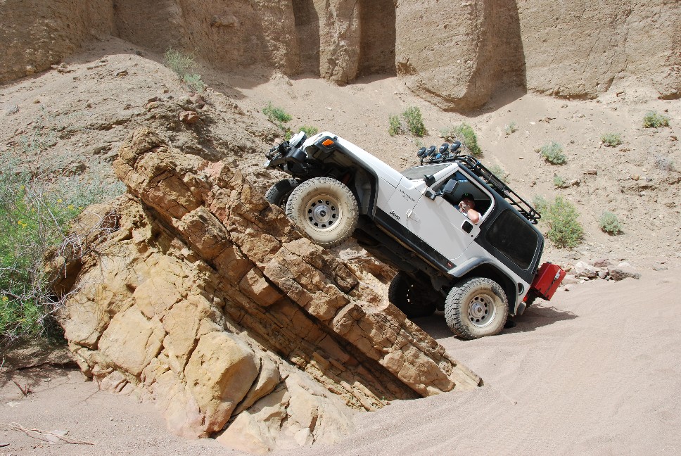 Bruce posing on a slab while waiting for the rest of the group to come out of Red Canyon.