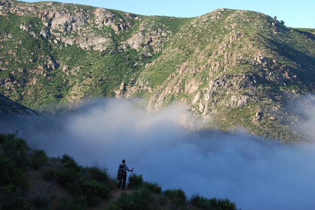 John standing at the top of the trail before dropping down the nasty descent. The falls are under that cloud layer.