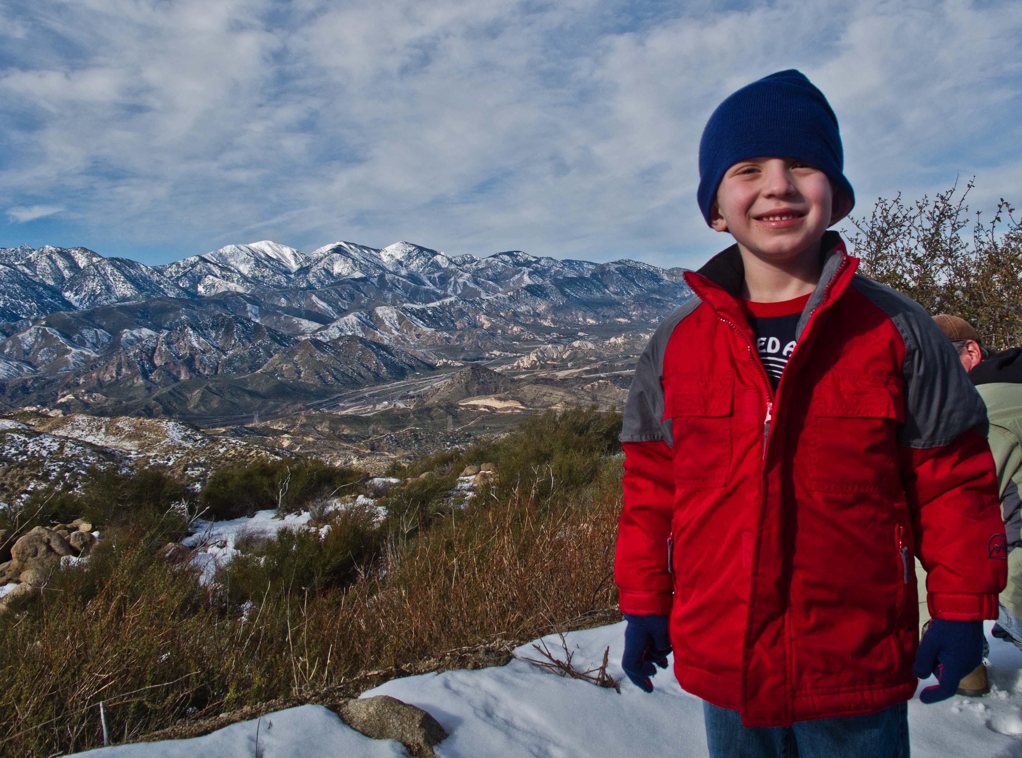 My son getting his first taste of snow.