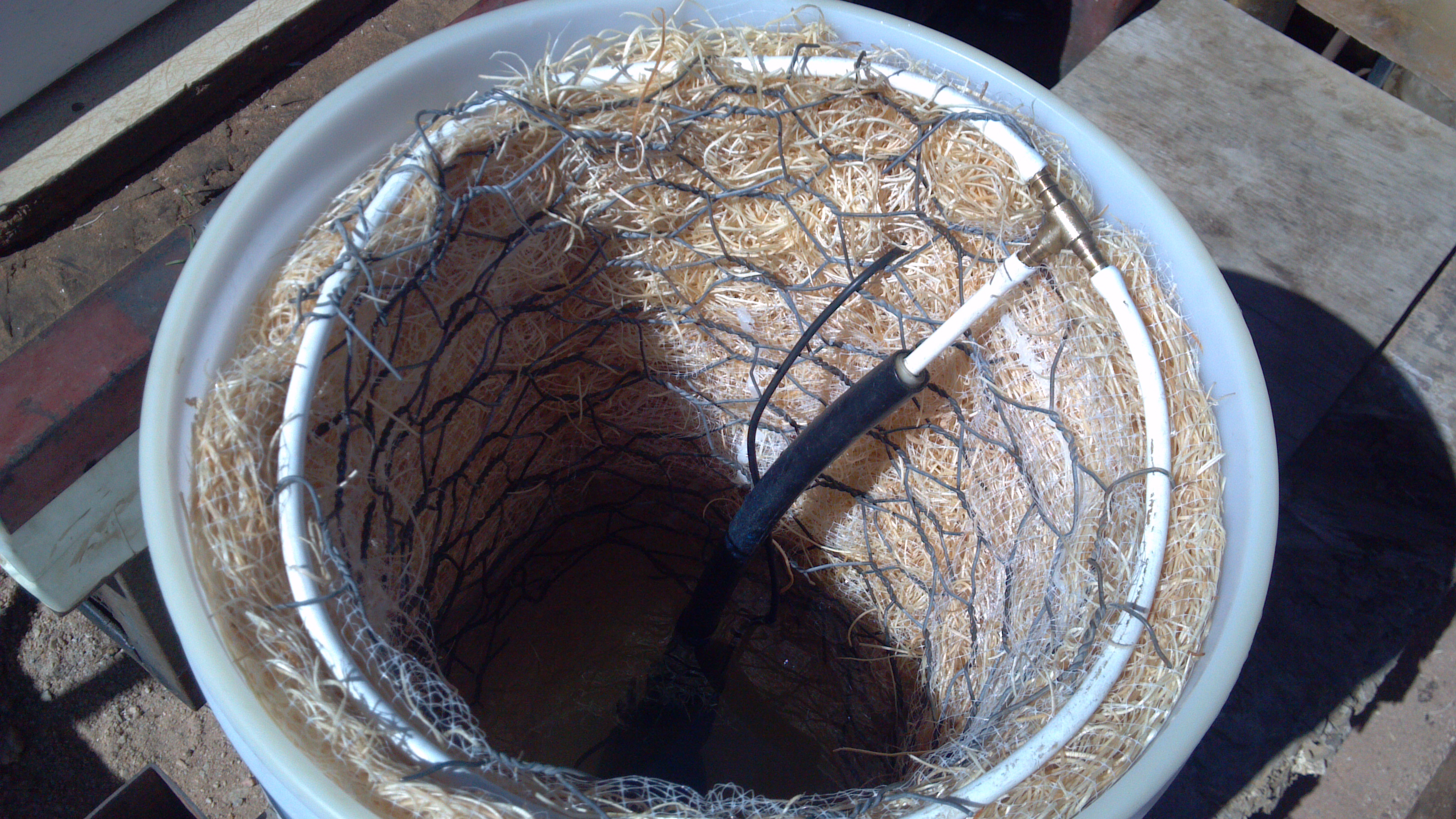 this is a shot of the bottom of the top bucket to show the wholes is cut the bottom the show with pump goes through to the other bucket