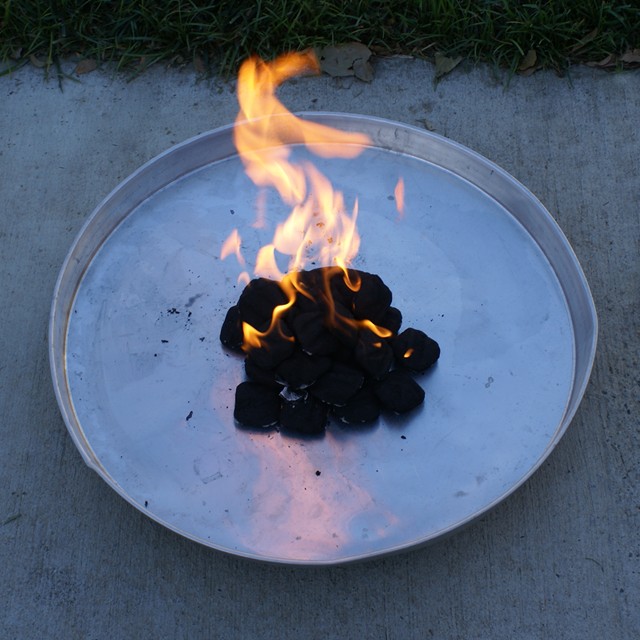 03:  Keeping the environment safe from ashes and open flame threat.  This is a water heater pan found at most hardware stores.  I have also used some old stainless cookie tins that are okay in a mild breeze, but not recommended in a windy-gusty environment.  The group will discuss the suggested use of coals and trays once the cooking is done...wait for it, wait for it...