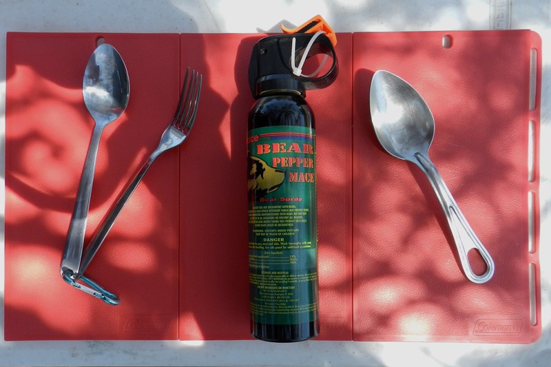 6.	I like utensils with hanging and clipping points.  I usually have bear spray centrally located for unwanted guests.  Coleman snap together cutting board on Lifetime folding table.