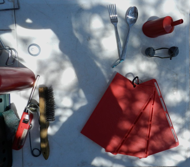 5.	Points of interest in this photo (12 o'clock going clockwise):<br />A.	Utensils on a snap link<br />B.	Red fuel funnel (standard) but below in grey I have the cap for a stainless fuel bottle 550ed to that the special top with pour spout<br />C.	Snap together cutting board<br />D.	Wire brush, striker, extended reach lighter, green pad<br />E.	Liter fuel bottle<br />F.	Center bubble level
