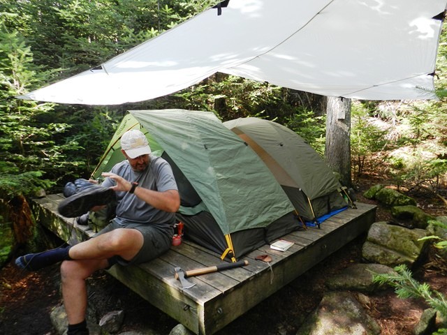 Carrying a full blown canvas tent might just get you heatstroke if you're using your back and leather personnel carriers to get you around.  Your personal one person tent and a makeshift  canopy ($20 from Sportsman's Guide) can make a difference in comfort when out and about.  Eureka Backcountry I and II about the $100 price point.