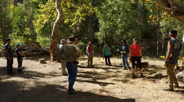 Dave leads us in a song while the onlookers think of the wine and potluck meal.