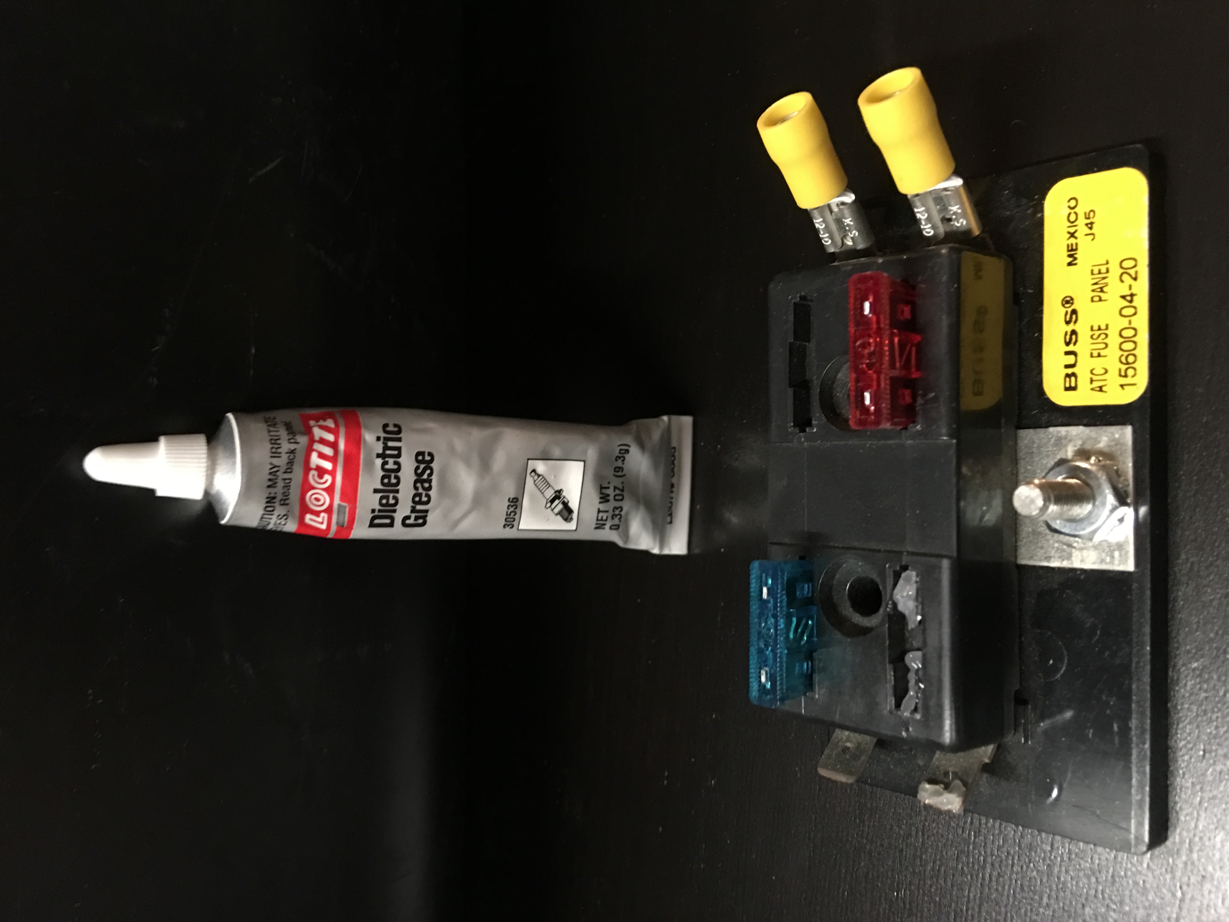 Apply grease before inserting fuse.