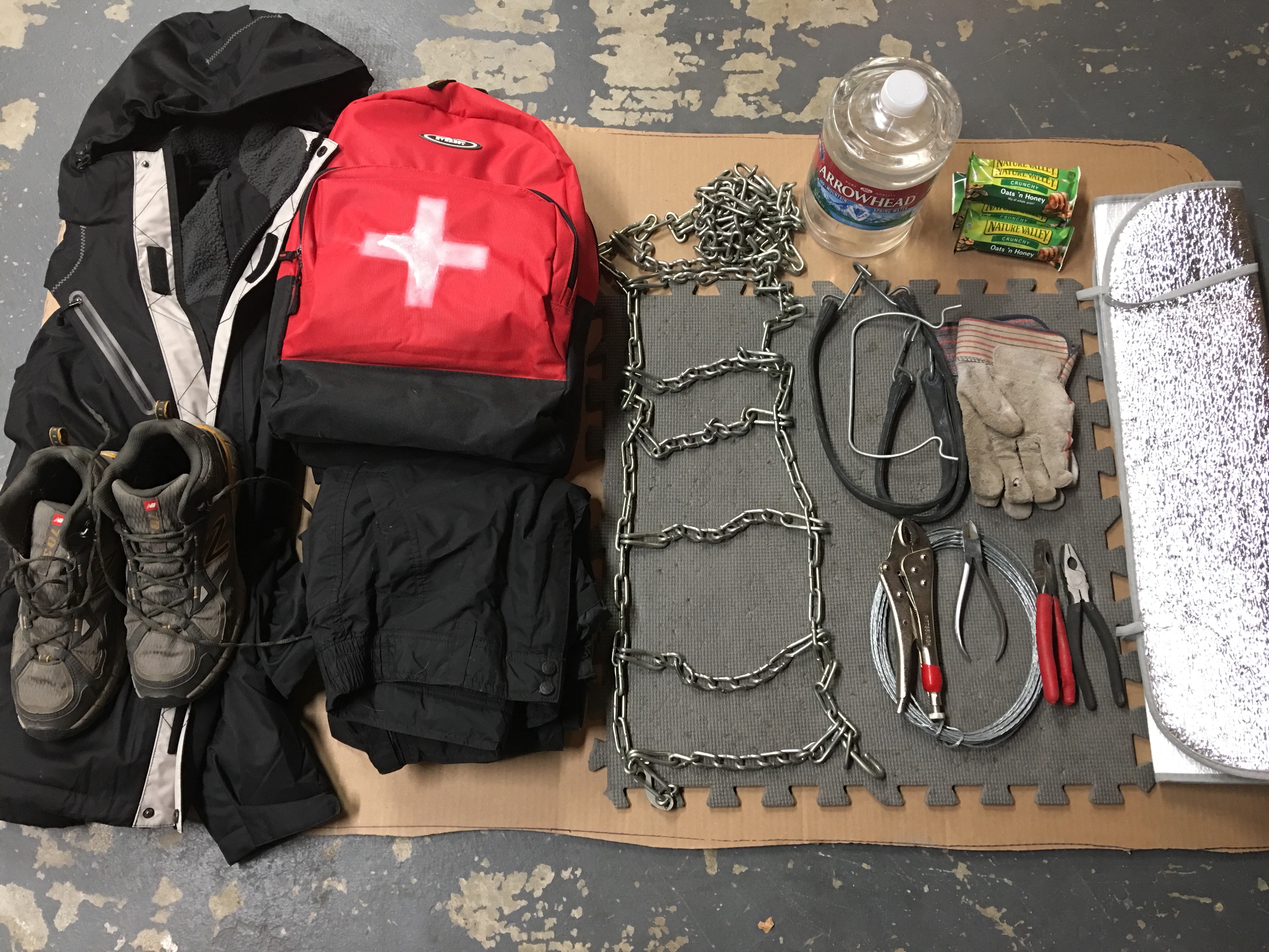 Warm clothes, first aid kit, tire chains and tools to install them, food and water should be included in any winter travel. In addition, inexpensive foam floor tiles and window sun shades can prove valuable insulators if you have to work on your vehicle in bad weather or are stranded for a period of time.