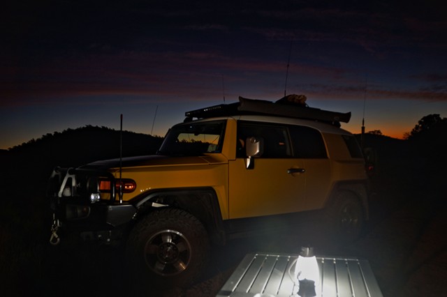 03. FJ by the light of the half dozen daisy-chained Goal Zero lamps connected to a SLA battery power supply and the glow of the setting sun.